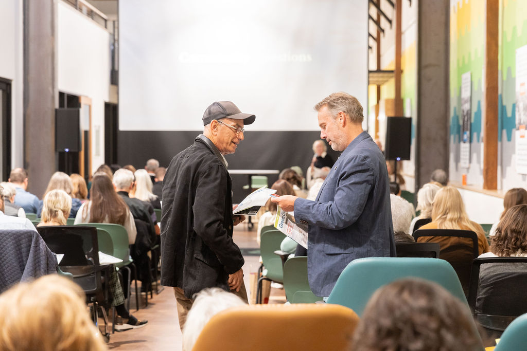 Mark Sylvester talking with an attendee after the screenings.